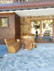a patio with a bench and a table and a building at студио Е 13 in Pamporovo