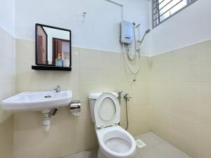 a bathroom with a toilet and a sink at R3troHouse3 4BR 14PAX Near188Tower, HTAA, In Town in Kuantan