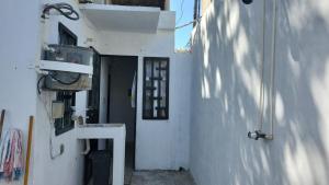 a hallway of a white building with a door at Casita Puerto Maya in Puerto Aventuras