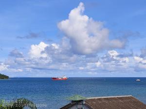 a large red ship in the middle of the ocean at The Seaview Residency in Port Blair
