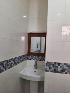 a bathroom with a sink and a mirror at Serena10 in Mombasa +34 photos