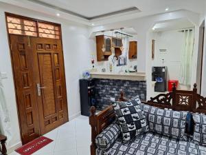 a living room with a couch and a kitchen at Serena10 in Mombasa