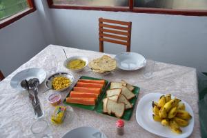 a table with a plate of food on a table at Hilltop Panorama Ohiya in Ohiya +29 photos