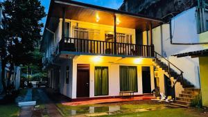 a house with a balcony on the side of it at Amadio Beach Resort in Hikkaduwa +29 photos