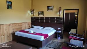 a bedroom with a large bed with a large headboard at Executive Guest House in Guwahati