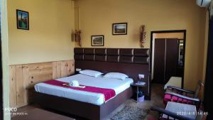 a bedroom with a large bed in a room at Executive Guest House in Guwahati +3 photos