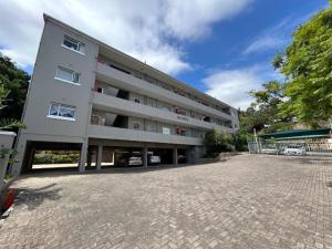 an empty parking lot in front of a building at Number 5 Beau Rivage in Knysna