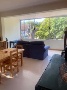 a living room with a blue couch and a table at Number 5 Beau Rivage in Knysna