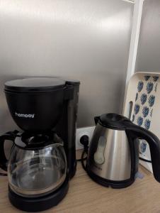 a coffee maker and a toaster on a table at chalet proche de la mer in La Crau