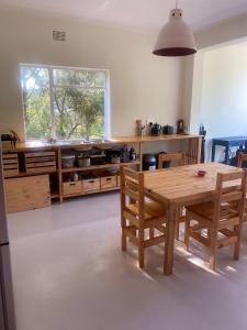 a kitchen with a wooden table and wooden cabinets at Number 5 Beau Rivage in Knysna