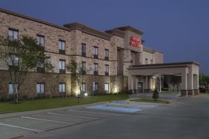 a hotel with a parking lot in front of it at Hampton Inn & Suites - Mansfield in Mansfield