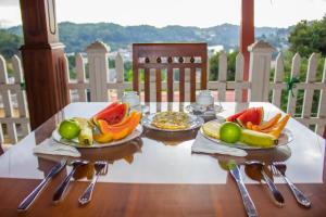 a table with two plates of fruit on it at Satyodaya Educational Training Centre in Kandy