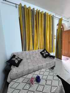 a bedroom with gold curtains and a bed in a room at Shiva in Hāpur