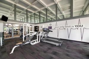 a gym with two tread machines and a treadmill at Clarion Inn & Suites Across From Universal Orlando Resort in Orlando