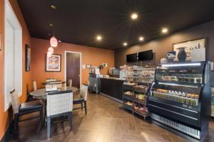 a fast food restaurant with a counter and a bakery at Clarion Inn & Suites Across From Universal Orlando Resort in Orlando