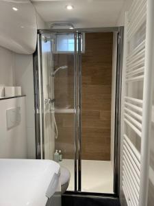 a bathroom with a shower and a toilet at La Suite Bellifontaine in Fontainebleau