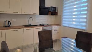 a kitchen with a glass table and a sink at Biserka hidden gem of the island Hvar in Pitve