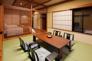a dining room with a wooden table and chairs at Hinanoyado Chitose in Tokamachi +92 photos