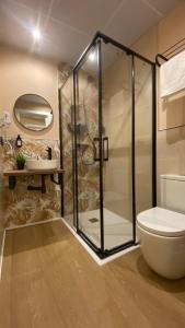 a bathroom with a shower and a toilet and a sink at Marina Boutique in Valencia