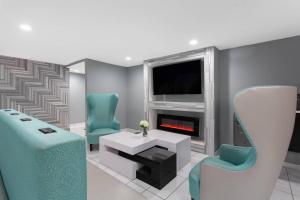 a living room with two chairs and a fireplace at Clarion Pointe in Charlotte