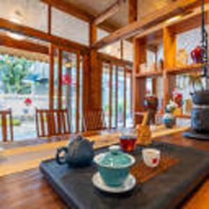 a living room with a table with a bowl on it at 赛家花园酒店SAI JIA Garden HOTEL in Dali Ancient Town +36 photos