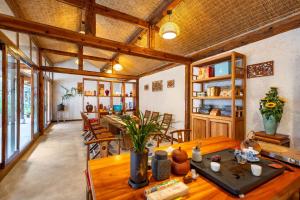 a dining room with a wooden table and chairs at 赛家花园酒店SAI JIA Garden HOTEL in Dali Ancient Town