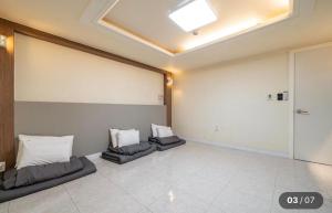 a large room with two pillows on the floor at Hotel Social Stay in Pocheon