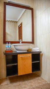a bathroom with a sink and a mirror at Kilimanjaro Wonders Hotel in Moshi
