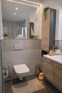 a bathroom with a toilet and a sink at ErzZeit Urlaub mit Weitblick in Schwarzenberg/Erzgebirge +9 photos