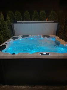 a hot tub with blue water at night at Chaty u Wiktora in Białka Tatrzańska