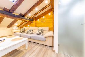 a living room with a couch and a table at Cozy Attic in the City Center of Soria in Soria