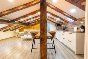 a kitchen with white cabinets and a table in a room at Cozy Attic in the City Center of Soria in Soria