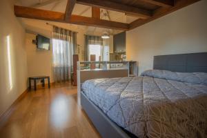 a bedroom with a bed and a wooden floor at Bed and Breakfast La Panarda in Subiaco