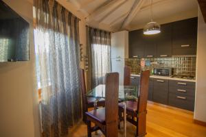 a dining room with a table and chairs and a kitchen at Bed and Breakfast La Panarda in Subiaco