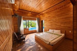 a bedroom with a bed in a wooden room at Trang An ViewPoint Homestay in Ninh Binh