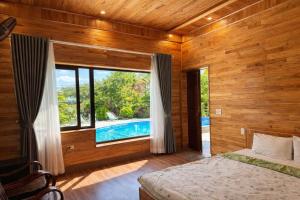 a bedroom with a bed and a swimming pool at Trang An ViewPoint Homestay in Ninh Binh
