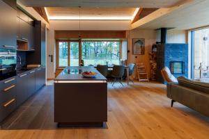a kitchen with a island in the middle of a room at Villa SEE la vie in Rheinsberg