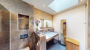 a bathroom with a sink and a mirror at Villa SEE la vie in Rheinsberg +32 photos