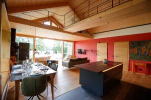 a kitchen and living room with a dining table at Villa SEE la vie in Rheinsberg