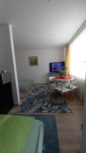 a room with a bed and a table in a room at Studiou Elena in Lupeni