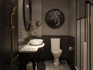 a bathroom with a white toilet and a sink at The Emissary Hanoi Hotel & Spa in Hanoi