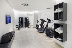 a gym with treadmills and exercise bikes in a room at Hotel Parco Smeraldo Terme in Ischia