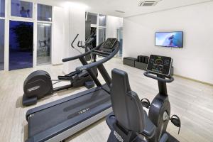 a fitness room with a treadmill and a tv at Hotel Parco Smeraldo Terme in Ischia