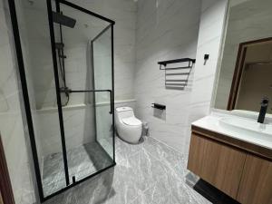 a bathroom with a shower and a toilet and a sink at Firdaus Cafe& Hotel in Ban Bo So +23 photos