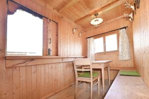 a dining room in a log cabin with a table and chairs at UNSER VORSÄSS - Klausberg in Schwarzenberg