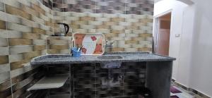 a bathroom with a sink and a brick wall at Osama House Luxor in Al Qurnah +69 photos