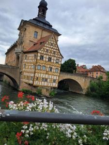 a building next to a river with a bridge at Gästehaus Leonie in Ebrach