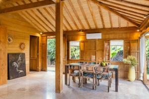 a dining room with a table and chairs at Villa Lucky in Canggu +3 photos