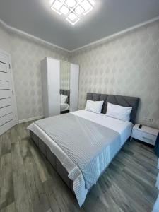 a bedroom with a large bed in a room at Nika apartment in Odesa