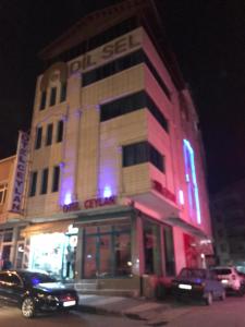 a building with blue lights on the side of it at Ceylan otel in Suşehri +7 photos